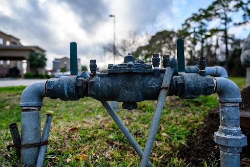 A backflow prevention device installed by a professional plumber in Springfield, MO, on a residential property for water maintenance.